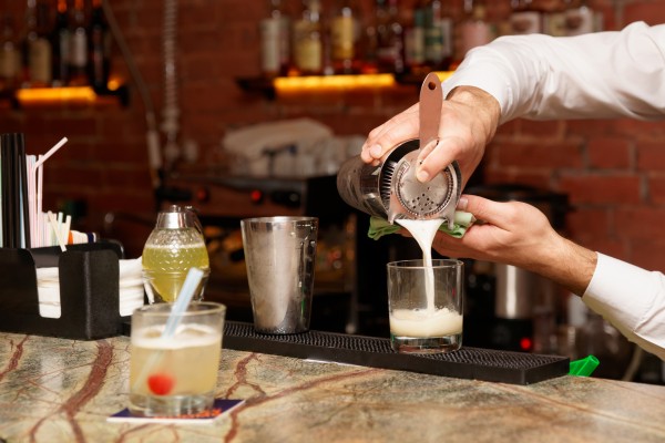 Bartender is making cocktail at bar counter